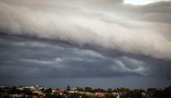 Storm clouds move over houses in northern Sydney on November 9, 2023. (Photo by DAVID GRAY / AFP)