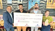 Nando's officials with display cheque of the cash donation in support of the Breast Cancer Awareness 