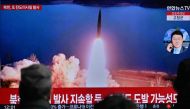 File Photo: People watch a television showing a news broadcast with file footage of a North Korean missile test, at a railway station in Seoul on March 19, 2023. (Photo by Anthony Wallace / AFP)