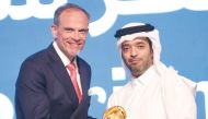 Chairman of Qatar Tourism Saad bin Ali Al Kharji giving award to General Manager of Hilton Salwa Beach Resort & Villas Etienne Gailliez.