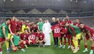 Qatar strikers Almoez Ali (right) and Akram Afif holding jerseys to mark their 100th international-match milestones along with QFA President Jassim Rashid Al Buenain and Qatar head coach Carlos Queiroz besides teammates.