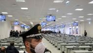 (FILES) A Carabinieri police officer wearing a face mask stands guard as a general view shows a special courtroom on January 13, 2021 on the opening day of the 'Rinascita-Scott' maxi-trial in which more than 350 alleged members of Calabria's 'Ndrangheta mafia group and their associates go on trial in Lamezia Terme, Calabria. (Photo by Gianluca CHININEA / AFP)
