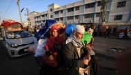Palestinians who had taken refuge in temporary shelters return to their homes in eastern Khan Yunis in the southern Gaza Strip on November 24, 2023. (Photo by Mahmud Hams / AFP)
