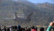 An IAF Chinook helicopter carrying rescued workers to a hospital in Rishikesh takes off at Chinyalisaur airstrip in Uttarakashi district of Uttarakhand State on November 29, 2023. (Photo by Sajjad Hussain / AFP)
 