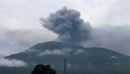 Volcanic ash spews from Mount Marapi during an eruption as seen from Batu Palano village in Agam on December 4, 2023. (Photo by Adi Prima / AFP)