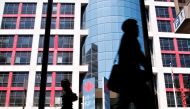 (FILES) Pedestrians walk in front of the Canadian Broadcasting Corporation (CBC) building in downtown Toronto on June 07, 2006. (Photo by GEOFF ROBINS / AFP)
