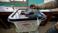 An Egyptian man casts his ballot at a polling station in Imbaba district during the presidential election in Cairo on December 11, 2023.(Photo by Khaled DESOUKI / AFP)
