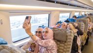 Passengers take selfies in a carriage of a high-speed electrical multiple unit (EMU) train running on the Jakarta-Bandung High-Speed Railway in Indonesia, recently. (Xinhua/Xu Qin)