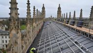 Solar panels are installed on the roof of King's College Chapel in Cambridge, eastern England on December 13, 2023. (Photo by Justin Tallis / AFP)