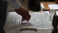 A man casts his vote during the referendum for Chile's new constitution proposal, in Santiago, on December 17, 2023. (Photo by Pablo Vera / AFP)
