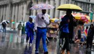 File photo: People walk under umbrellas during a coastal storm in Lower Manhattan on September 29, 2023 in New York City. (Photo by Eduardo Munoz Alvarez/Getty Images/AFP)