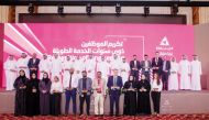 Qatar Rail Managing Director and CEO H E Dr. Abdullah bin Abdulaziz bin Turki Al Subaie with officials and employees with long service during a ceremony. 