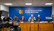 Prague's Police chief Petr Matejcek (C-R, in blue shirt) addresses a press conference on December 22, 2023 in Prague to inform about a deadly mass shooting at a university the day before. Photo by Radek Mica / AFP