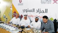 Officials during the annual auction of stamps and coins recently.