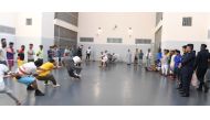 Officials watch as inmates take part in a sports competition. 