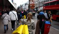 Shoppers carry their shopping bags along Oxford Street during the Boxing Day sales in London on December 26, 2023. (Photo by HENRY NICHOLLS / AFP)
