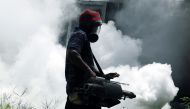 A worker sprays insecticide to prevent mosquito breeding at a railway station in Colombo, Sri Lanka, May 13, 2023. Photo by Ajith Perera/Xinhua