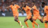 :Ivory Coast's midfielder #6 Seko Fofana (C) celebrates scoring his team's first goal during the Africa Cup of Nations (CAN) 2024 group A football match between Ivory Coast and Guinea-Bissau at the Alassane Ouattara Olympic Stadium in Ebimpe, Abidjan, on January 13, 2024. (Photo by FRANCK FIFE / AFP)