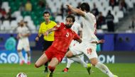 Palestine's defender #05 Mohammed Saleh and Iran's forward #20 Sardar Azmoun vie for the ball during the Qatar 2023 AFC Asian Cup Group C football match between Iran and Palestine at the Education City Stadium in Al-Rayyan, west of Doha on January 14, 2024. (Photo by KARIM JAAFAR / AFP)
