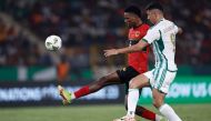 Angola's defender #5 Kinito fights for the ball runs with the ball Algeria's forward #9 Baghdad Bounedjah during the Africa Cup of Nations (CAN) 2024 group D football match between Algeria and Angola at Stade de la Paix in Bouake on January 15, 2024. (Photo by KENZO TRIBOUILLARD / AFP)