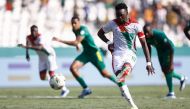 Burkina Faso's forward #10 Bertrand Traore shoots and scores his team's first goal from a penalty kick during the Africa Cup of Nations (CAN) 2024 group D football match between Burkina Faso and Mauritania at Stade de la Paix in Bouake on January 16, 2024. (Photo by KENZO TRIBOUILLARD / AFP)