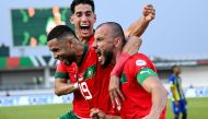 Morocco's defender #6 Romain Saiss (R) celebrates with Morocco's forward #19 Youssef En-Nesyri (C) and Morocco's defender #5 Nayef Aguerd (L) after scoring his team's first goal during the Africa Cup of Nations (CAN) 2024 group F football match between Morocco and Tanzania at Stade Laurent Pokou in San Pedro on January 17, 2024. (Photo by SIA KAMBOU / AFP)