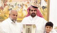 Director of Media Development Department at Qatar Media Corporation, Sheikh Khalid bin Abdulaziz Al Thani (centre) with Al Jazeera journalist Wael Al Dahdouh.
