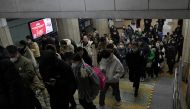 People are seen at a subway station in Beijing on January 17, 2024. Photo by Pedro PARDO / AFP