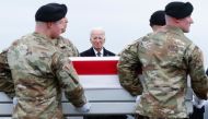 US President Joe Biden places his hand over his heart while watching a US Army team move a flagged draped transfer case containing the remains of Army Sgt. William Rivers during a dignified transfer on February 02, 2024. Kevin Dietsch/Getty Images/AFP 