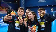Great Britain's athletes pose for a selfie with their medals after winning the mixed team event.