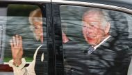 Britain's King Charles III and Britain's Queen Camilla wave as they leave by car from Clarence House in London on February 6, 2024. (Photo by Henry Nicholls / AFP)

