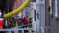 Firefighters inspect a building as emergency services are looking for potential victims after a habitation building has collapsed, in Badalona on February 6, 2024. (Photo by Pau Barrena / AFP)