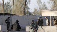 File photo of Afghan security forces stand guard at the entrance gate of Kandahar Airport 