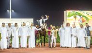 The connections of Townsend Manor celebrate after the Al Rufaa Racing-owned Townsend Manor won the Class 2 Ain Khaled Cup for Thoroughbreds at Al Rayyan Racecourse, yesterday. PICTURES: JUHAIM/QREC