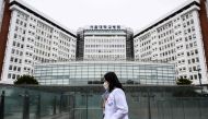 A medical worker walks past the Seoul National University Hospital in Seoul on February 21, 2024. Photo by ANTHONY WALLACE / AFP