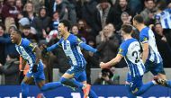 Brighton's Japanese midfielder Kaoru Mitoma (centre) celebrates with teammates after scoring their second goal during the English FA Cup fourth round football match between Brighton & Hove Albion and Liverpool at the Amex stadium in Brighton, on the south coast of England on January 29, 2023. (Photo by Glyn KIRK / AFP)

