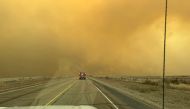 This handout picture courtesy of the Flower Mound Fire Department taken on February 27, 2024, shows a fire truck driving towards the Smokehouse Creek Fire, near Amarillo, in the Texas Panhandle. Photo by Flower Mound Fire Department / AFP
