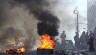 This screen grab taken from AFPTV shows tires on fire near the main prison of Port-au-Prince, Haiti, on March 3, 2024, after a breakout by several thousand inmates. (Photo by Luckenson Jean / AFPTV / AFP)
