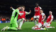 (From L) Arsenal's Spanish goalkeeper #22 David Raya, Arsenal's Norwegian midfielder #08 Martin Odegaard, Arsenal's English midfielder #07 Bukayo Saka, Arsenal's English defender #04 Ben White and Arsenal's English midfielder #41 Declan Rice celebrate after winning the penalty shoot-out session the UEFA Champions League last 16 second leg football match between Arsenal and Porto FC at the Arsenal Stadium in north London, on March 12, 2024. (Photo by Adrian DENNIS / AFP)
