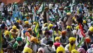 Farmers take part in a sit-in protest demanding minimum crop prices, loan waivers and an investigation into the death of a farmer during the farmers' protest 