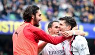 AC Milan's American forward #11 Christian Pulisic (R) celebrates with teammates after scoring his team second goal during the Italian Serie A football match between Hellas Verona and AC Milan, at the Marcantonio Bentegodi stadium, in Verona, on March 17, 2024. (Photo by Piero CRUCIATTI / AFP)
