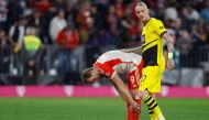Bayern Munich's English forward #09 Harry Kane and Dortmund's German midfielder #17 Marius Wolf (R) react after the German first division Bundesliga football match FC Bayern Munich v BVB Borussia Dortmund in Munich, southern Germany on March 30, 2024 (Photo by ALEXANDRA BEIER / AFP)
