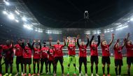 Bayer Leverkusen's players celebrate their team's 4-0 win after the German Cup (DFB-Pokal) semi-final football match between Bayer 04 Leverkusen and Fortuna Duesseldorf in Leverkusen, western Germany on April 3, 2024. (Photo by INA FASSBENDER / AFP)