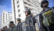 Police officers stand guard outside the Peruvian Prosecutor's building in Lima on April 5, 2024, before the arrival of President Dina Boluarte, summoned by prosecutors amid a scandal over her luxury Rolex and jewelry collection. (Photo by Ernesto BENAVIDES / AFP)
