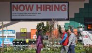 (FILES) Home Depot customers walk by a posted now hiring sign on March 8, 2024 in San Rafael, California. (Photo by JUSTIN SULLIVAN / GETTY IMAGES NORTH AMERICA / AFP)
