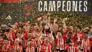 Athletic Bilbao's players celebrate victory with their Copa del Rey trophy at the end of the Spanish Copa del Rey (King's Cup) final football match between Athletic Club Bilbao and RCD Mallorca at La Cartuja stadium in Seville on April 6, 2024. (Photo by JAVIER SORIANO / AFP)