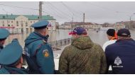 This photo taken from a video released by the Russian Emergency Situations Ministry on April 7, 2024 shows rescuers inspecting a flooded area in the town of Orsk, Orenburg region, southeast of the southern tip of the Ural Mountains. (Photo by Handout / Russian Emergencies Ministry / AFP)