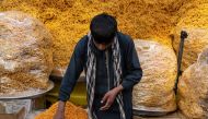 An Afghan vendor selling dry fruits and other eatables waits for customers ahead of Eid al-Fitr, which marks the end of Muslim holy fasting month of Ramadan, at a market in Kabul on April 8, 2024. (Photo by Wakil KOHSAR / AFP)