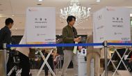 South Koreans cast their ballots during the parliamentary elections at a polling station located in a wedding hall in Seoul on April 10, 2024. (Photo by Jung Yeon-je / AFP)