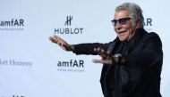 (FILES) Italian designer Roberto Cavalli arrives to attend the amfAR Milano 2013 at La Permanente during Milan Fashion Week on September 21, 2013. (Photo by Filippo MONTEFORTE / AFP)

